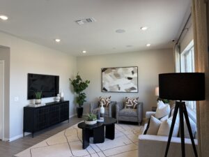 Living room with wood flooring in Plan 2218 at Catania at Citrine, Riverside, CA.