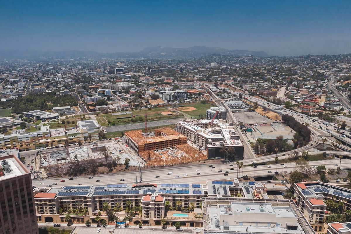 Overhead view of urban Los Angeles with housing development under construction and surrounding city landscape.